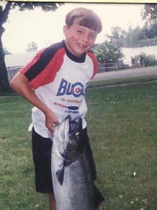 Bill's grandson trying to pick up a 35 pound salmon.jpg